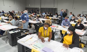 Gwinnett County Election Workers handle ballots as part of the recount for the 2020 presidential election.