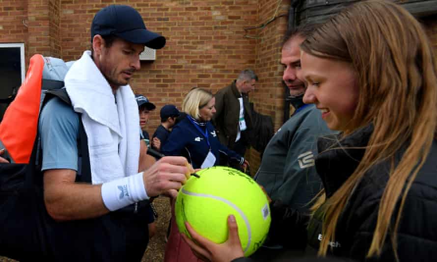 Andy Murray signs autographs for fans after winning his match against Jurij Rodionov in the Surbiton Trophy.