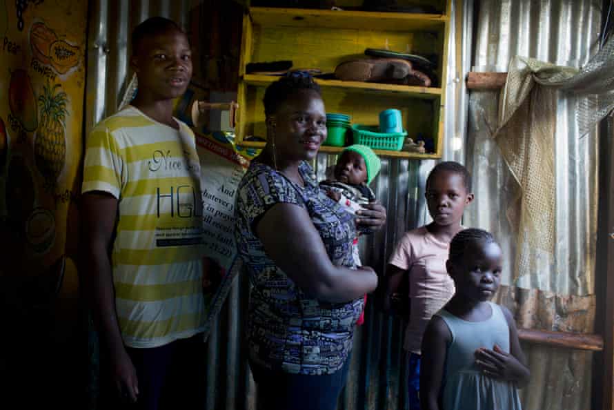 From left: Faizun Omondi, 15, Cody Achieng (mother) Aswin Gary (baby) Chelsea Dina, 9, and Denellythar June, 8 pose in their home in Kibera,