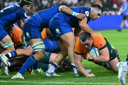 Angus Bell dives to score a try for Australia