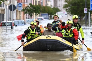 Rescuers evacuate a resident in Lugo