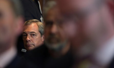 Nigel Farage listens to Paul Nuttall’s speech in London