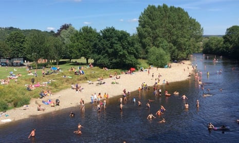 People out swimming, paddling and playing in the River Wharfe
