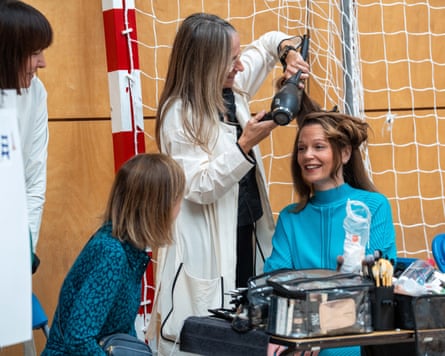 Victoria Starmer having her hair blow dried while chatting to someone in a school sports hall
