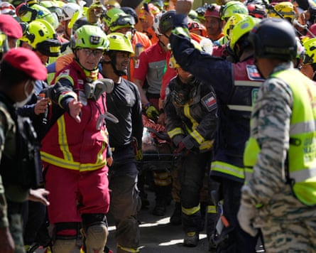 Rescue workers carry Hernán Alberto Gil Flores Gil after he was pulled from the rubble eight days after he was trapped by twin earthquakes that struck Catia La Mar, Venezuela