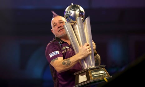 Peter Wright celebrates with the trophy.