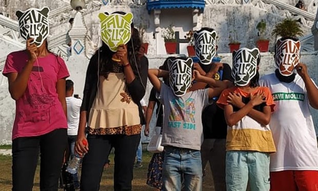 Young protesters wearing masks
