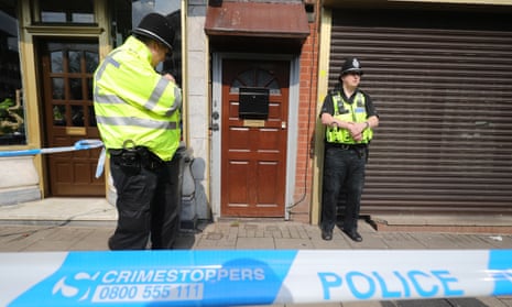 Police guard a Birmingham flat which was raided in connection with the Westminster attack