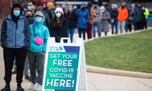 People wait in line at a walk-up vaccination site in Washington, DC as US president Joe Biden admits more Covid testing could have been done.