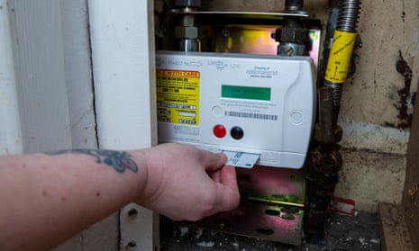 a householder inserts a prepayment credit card into a meter