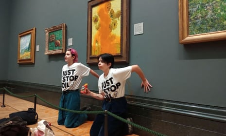 Just Stop Oil activists with their hands glued to the wall after throwing tomato soup on Vincent van Gogh’s Sunflowers at the National Gallery.
