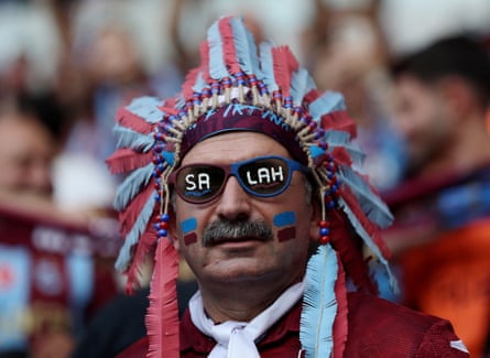 Excited Trabzonspor fan decked in traditional claret and sky blue colours sports sunglasses decorated with new signing Mohamed Salah.