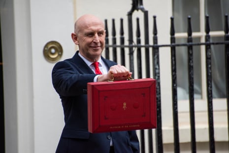 John Healey holding the iconic red box outside the 11 Downing Street in London.