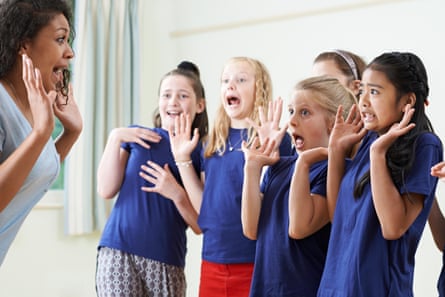 A group of children take a drama class.