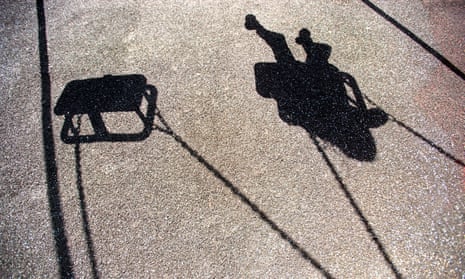 The shadow of a child playing on a swing