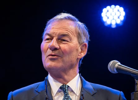 Rupert Lowe on stage in front of a mic