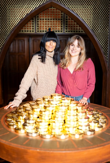 Claudia Winkleman and Elle Hunt with a giant pile of gold AKA the prize pot.