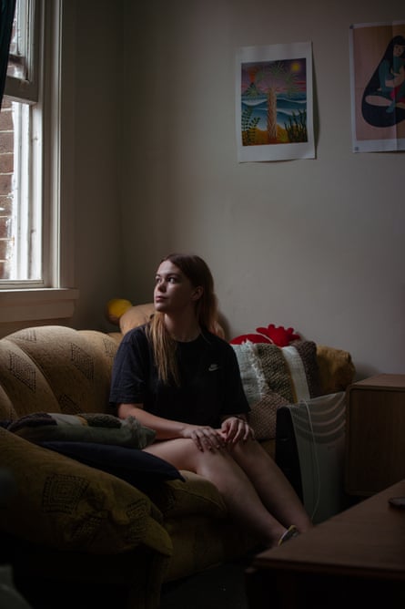 Amelia Grace Wilson-Williams looks out the window while sitting on a sofa in her family’s home