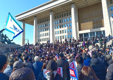 People protest outside the National Assembly in Seoul demanding the resignation of President Yoon Suk Yeol on 4 December 2024.