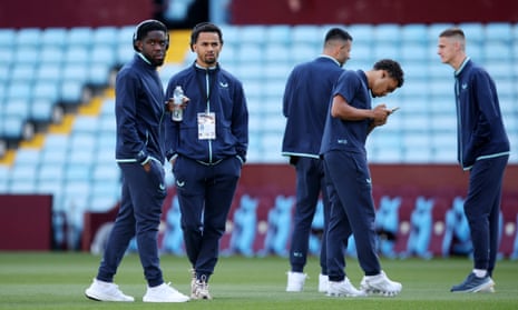 Assorted Everton players stroll around the pitch upon their arrival at Villa Park.