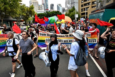 LGBTQ+ rights protesters march in front of St Mary’s Cathedral during Pell’s funeral.