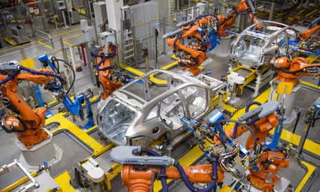 Robotic arms rivet car panels together in the aluminium body shop, part of Jaguar Land Rover's advanced manufacturing facility in Solihull