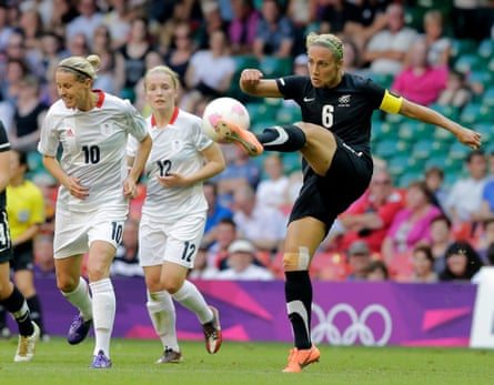 Bex Smith (right) clears the ball during an Olympics group game between New Zealand and Great Britain in 2012