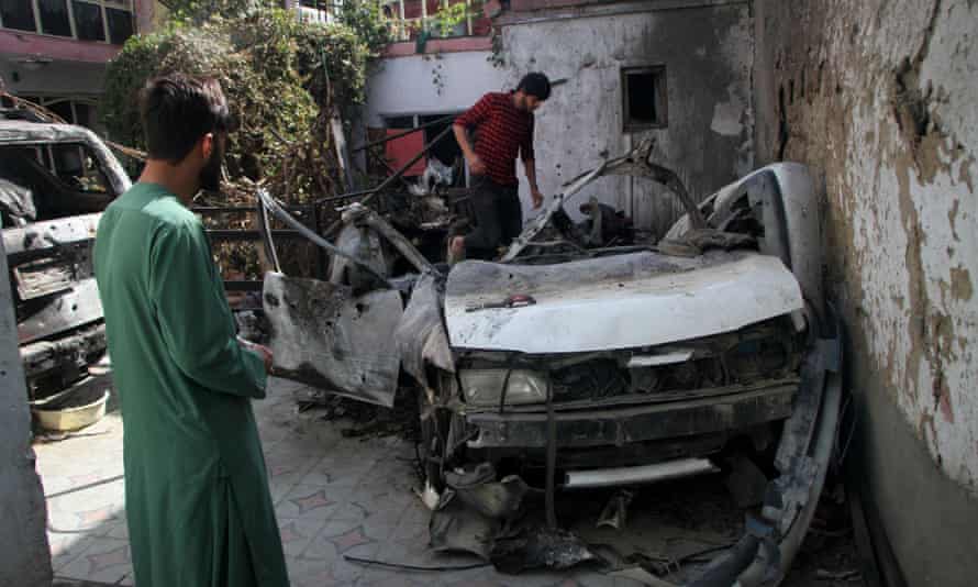 Damaged vehicles are seen on 2 September at the site of a deadly US airstrike in Kabul, capital of Afghanistan.