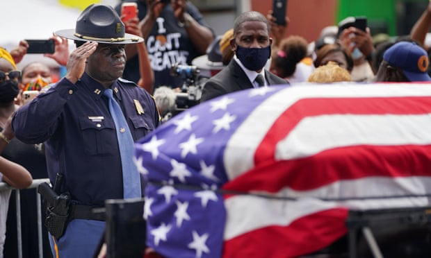 An Alabama state trooper salutes the casket.