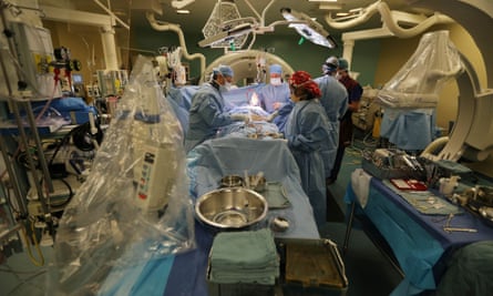 Doctors perform minimally invasive heart surgery on a patient.