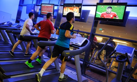 Men running on treadmills at the gym