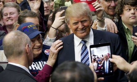 Donald Trump poses for a photo with a supporter in Plymouth, New Hampshire.