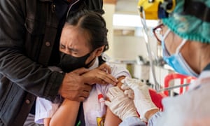 A school student receives an injection of the Covid vaccine during a mass vaccination campaign for adolescents in Denpasar, Bali, Indonesia, on July 5, 2021.