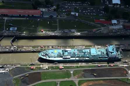 A merchant ship sails through the locks of the Panama Canal.