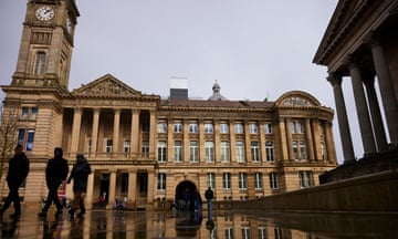 People walk past Council House in Birmingham