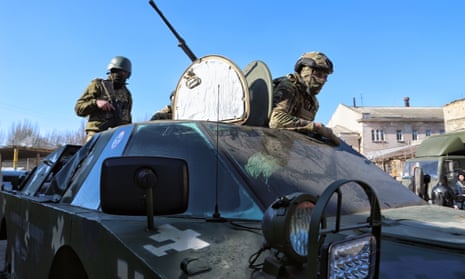 Ukrainian troops in an amphibious armoured scout car repaired by volunteers in Odesa, southern Ukraine
