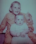An old photograph of a baby sitting on his brother’s lap