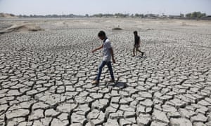 Two boys walk through a dried up Chandola Lake in Ahmadabad, India, May 2016