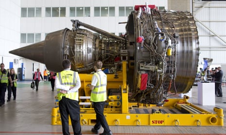 Staff examine a Rolls-Royce Trent 1000 turbofan engine