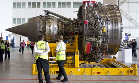 Staff survey a Rolls-Royce Trent 1000 turbofan engine