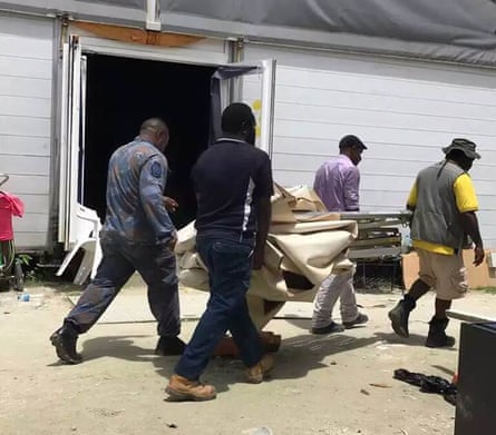 Papua New Guinean officials and police take away makeshift shelters built by refugees and asylum seekers on Manus Island.