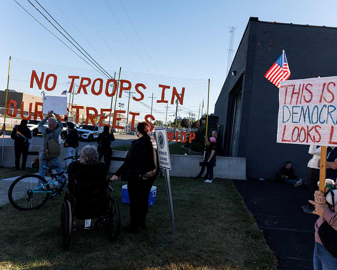 Activists stand outside a US Immigration and Customs Enforcement (ICE) detention facility with banners in October 2025