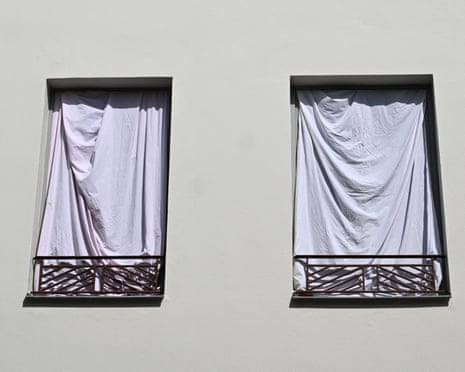 Windows covered by sheets in an attempt to reflect the heat as France experiences a heatwave, in Nantes, western France.