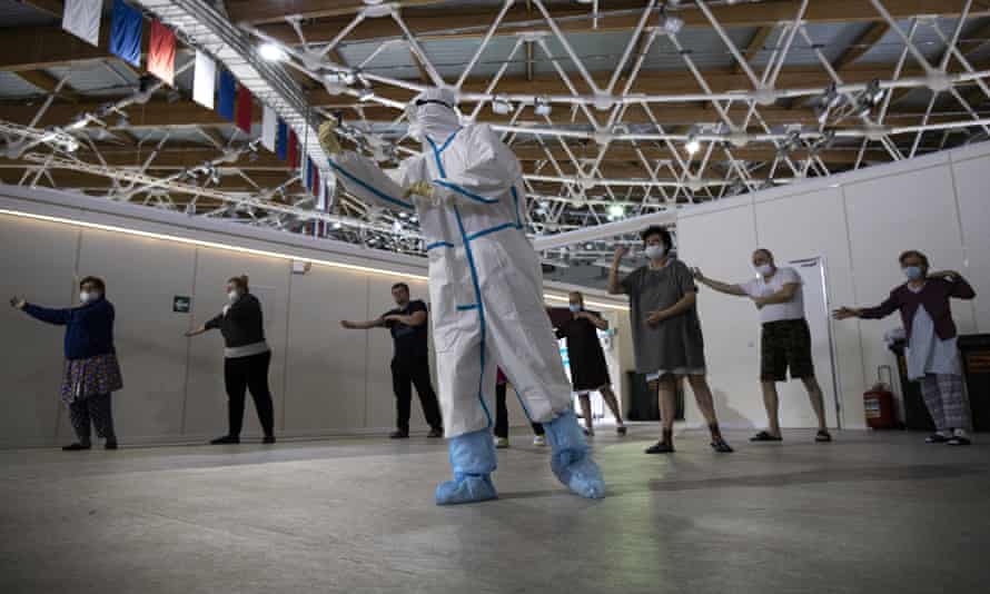 Coronavirus patients practising tai chi in rehab