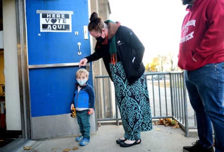 Ezra Horvath, 2, joins his parents in line before voting at the Kendrick recreation center in Philadelphia, Pennsylvania, on 8 November 2022