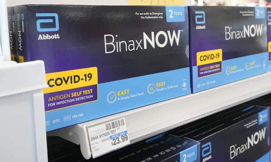 A store shelf holds boxes of BinaxNOW Covid rapid tests. The shelf tag marks them at $23.99.