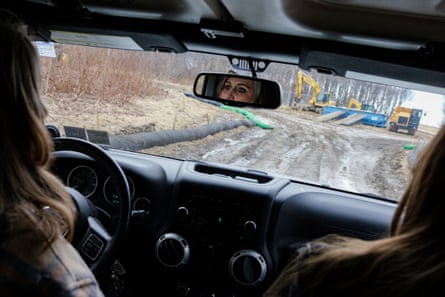 Beth Shoff and her daughter, Malyn, drive through a muddy webwork of new natural gas pipeline construction in the forest near their home.