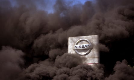 Smoke rises over the Nissan factory as workers burn tyres during a protest over the closure of the Barcelona plant.