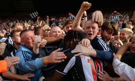 Allan Saint-Maximin is mobbed by Newcastle fans after scoring against Southampton this season.