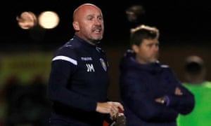Colchester manager John McGreal during his side’s Carabao Cup win over Spurs in September which hastened Mauricio Pochettino (right) towards the exit.